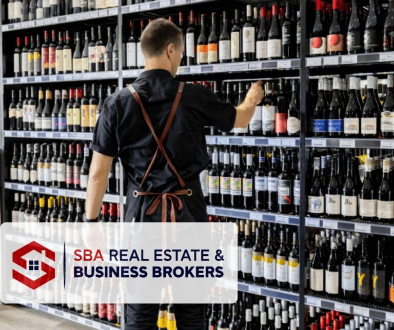 Person selecting bottles in a wine shop.