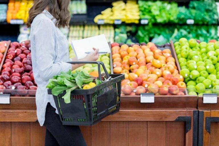 Person shopping for fresh produce in supermarket.