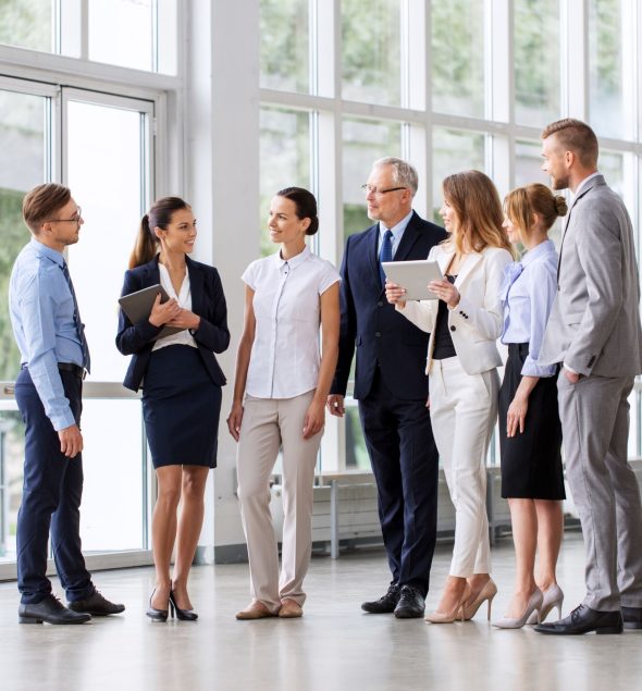 Group of professionals engaging in discussion indoors.